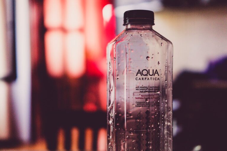 Crafting Captivating Headlines: Your awesome post title goes here Detailed view of an Aqua Carpatica water bottle with droplets and blurred background.